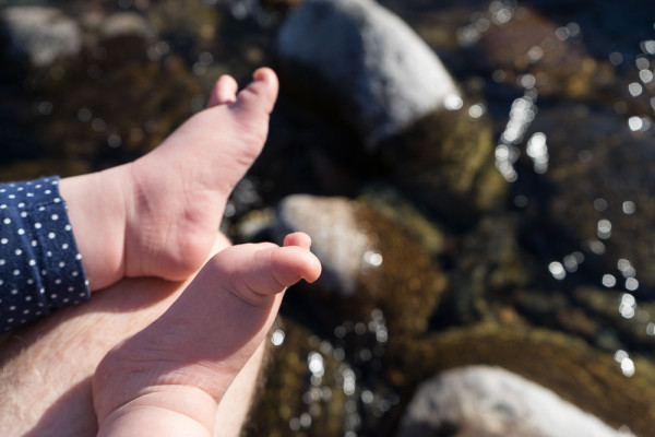 baby steps – little feet enjoying the warmth of the sun