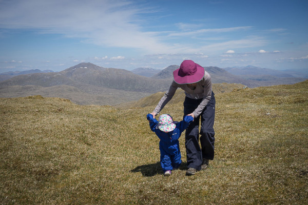 Getting some exercise out of the baby carrier, on the grassy summit of Beinn Bhuide