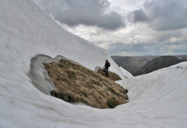 Exploring a large snow patch above The Gaick in May 2014